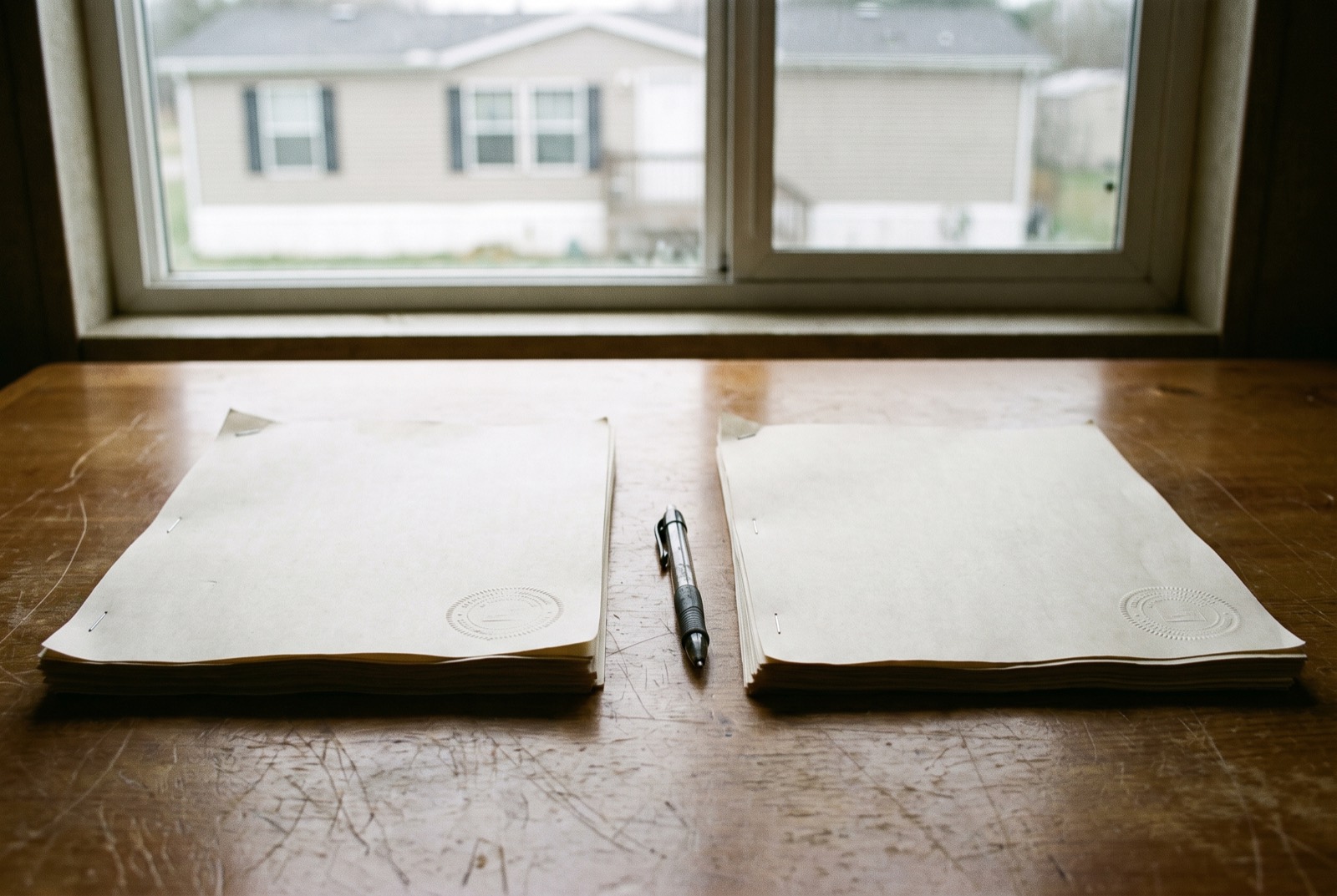 Two sealed documents side by side on a desk